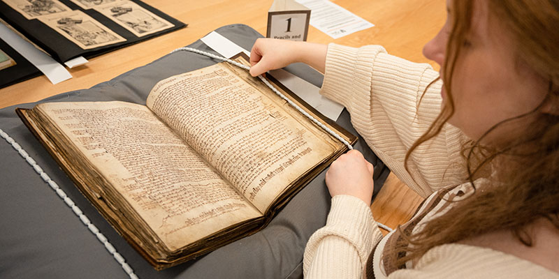 A student reading an old text in the Borthwick Archives
