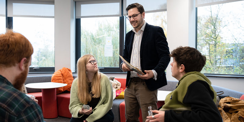 An academic talking to a group of students