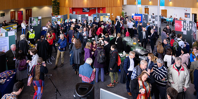 A wide angle image of delegates gathering at a conference