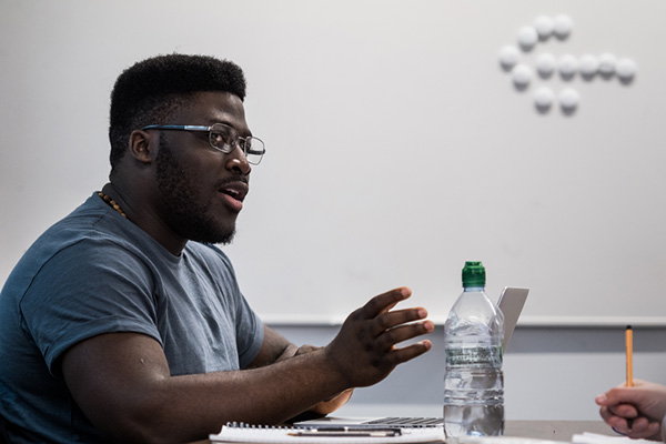 A student answering a question in a seminar