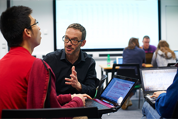 A student in discussion with a tutor